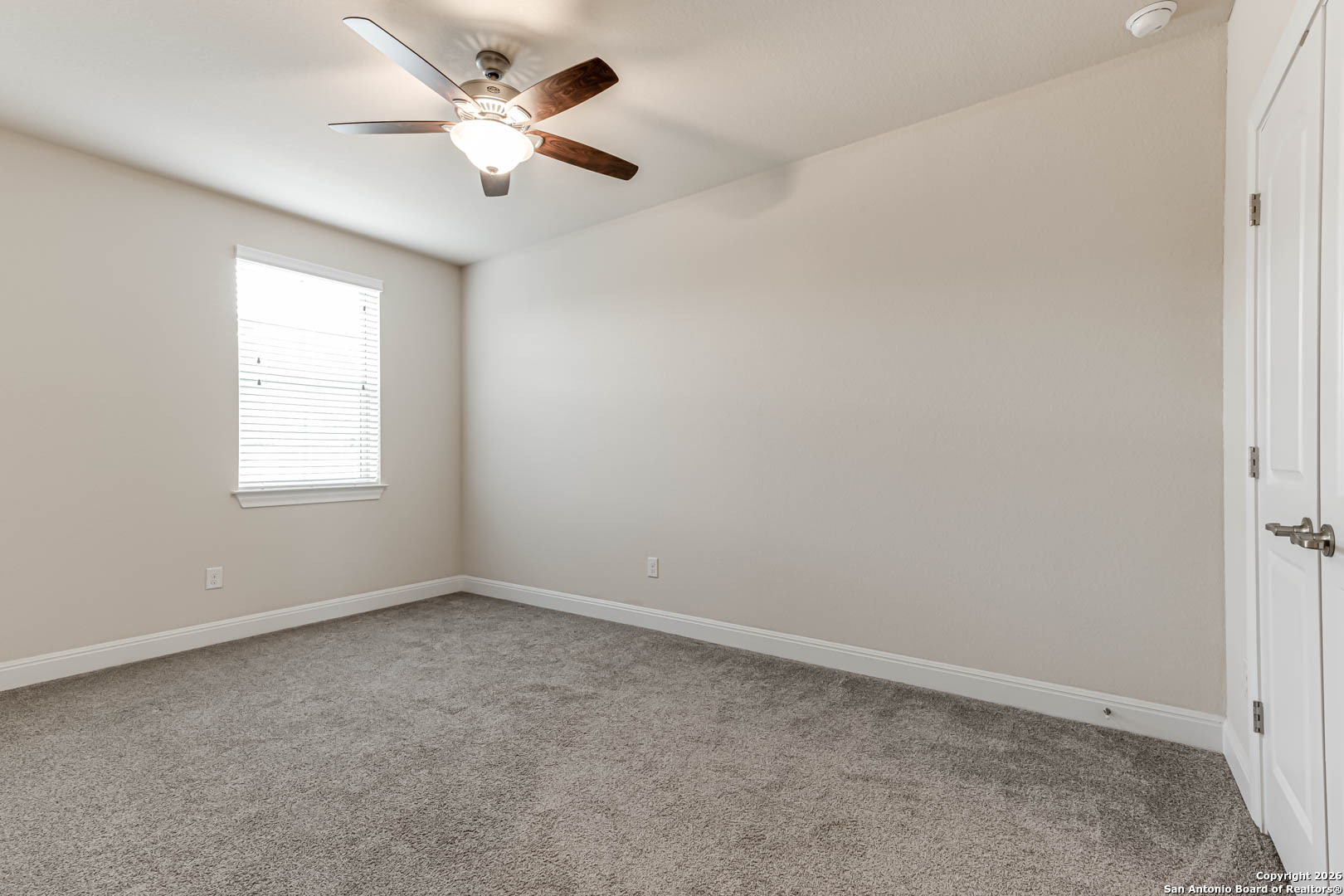 17419 Hillsedge Road San Antonio, TX 78257 - Photo 39 of 57 an empty room with a window and a fan