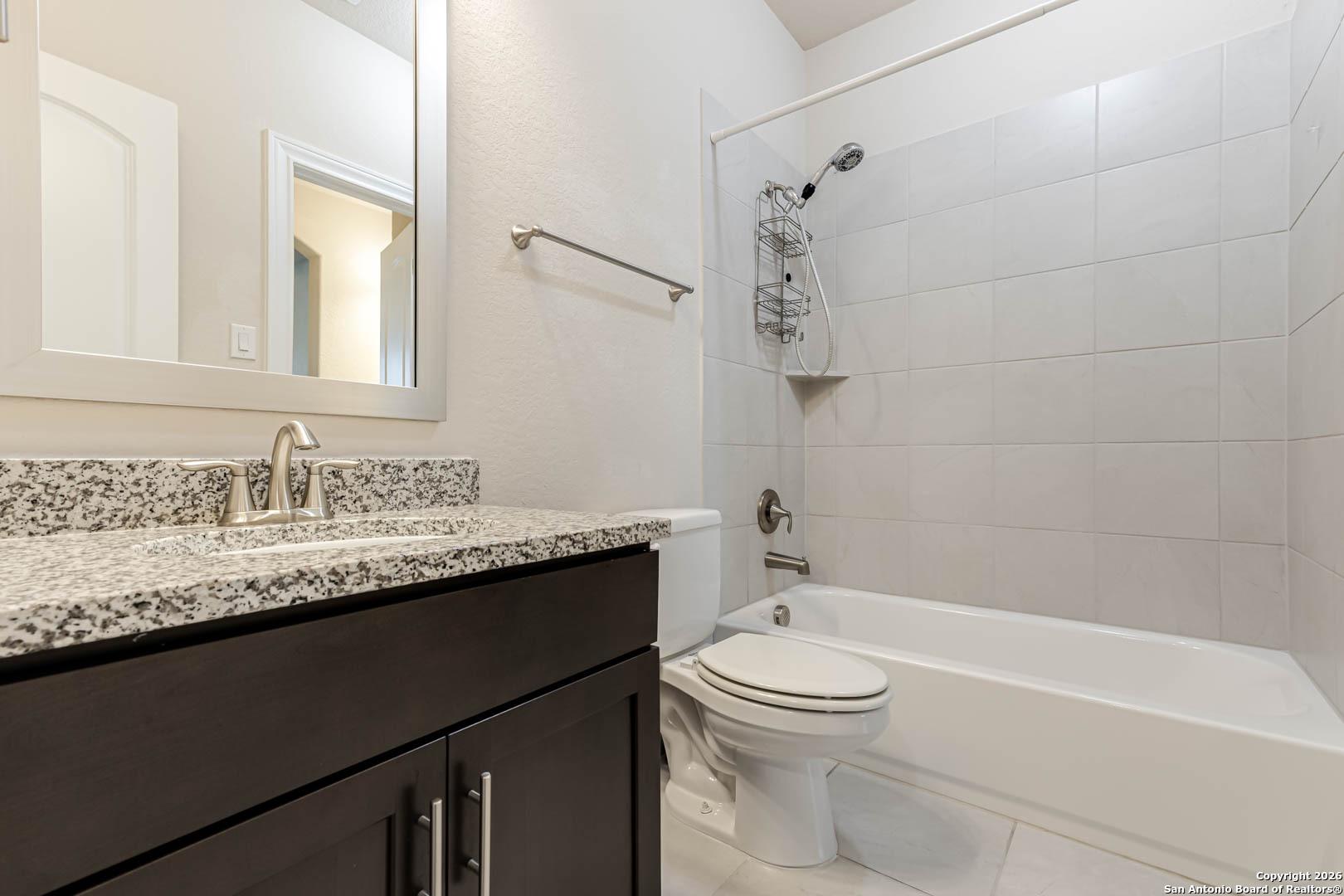 17419 Hillsedge Road San Antonio, TX 78257 - Photo 40 of 57 a bathroom with a granite countertop sink a toilet and bathtub