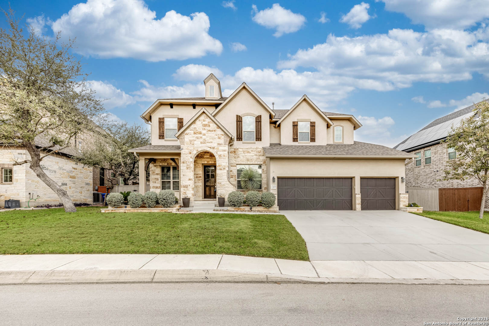 17419 Hillsedge Road San Antonio, TX 78257 - Photo 55 of 57 a view of a white house with a large windows and a yard with plants and large tree