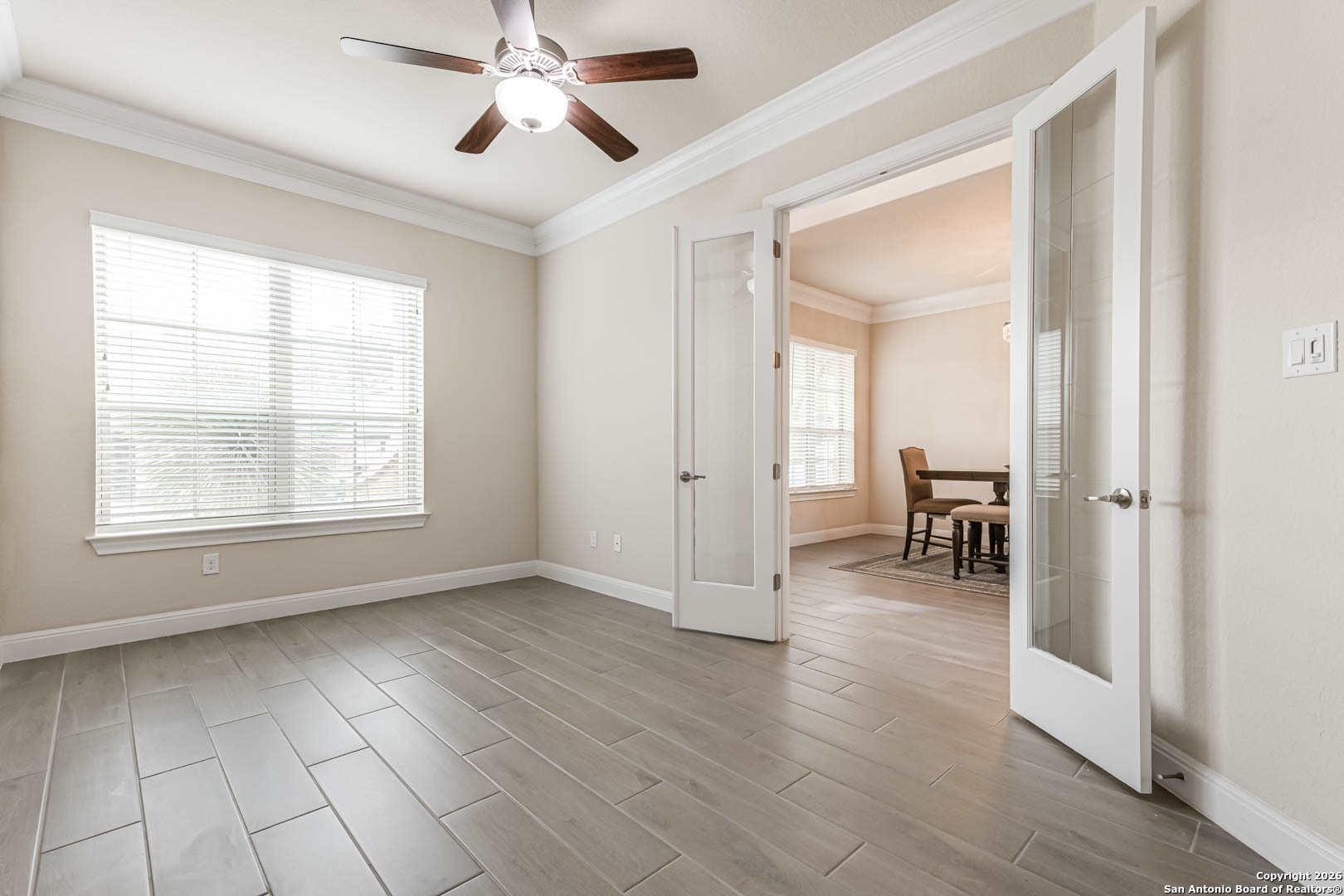 17419 Hillsedge Road San Antonio, TX 78257 - Photo 9 of 57 a view of a livingroom with wooden floor a ceiling fan and windows