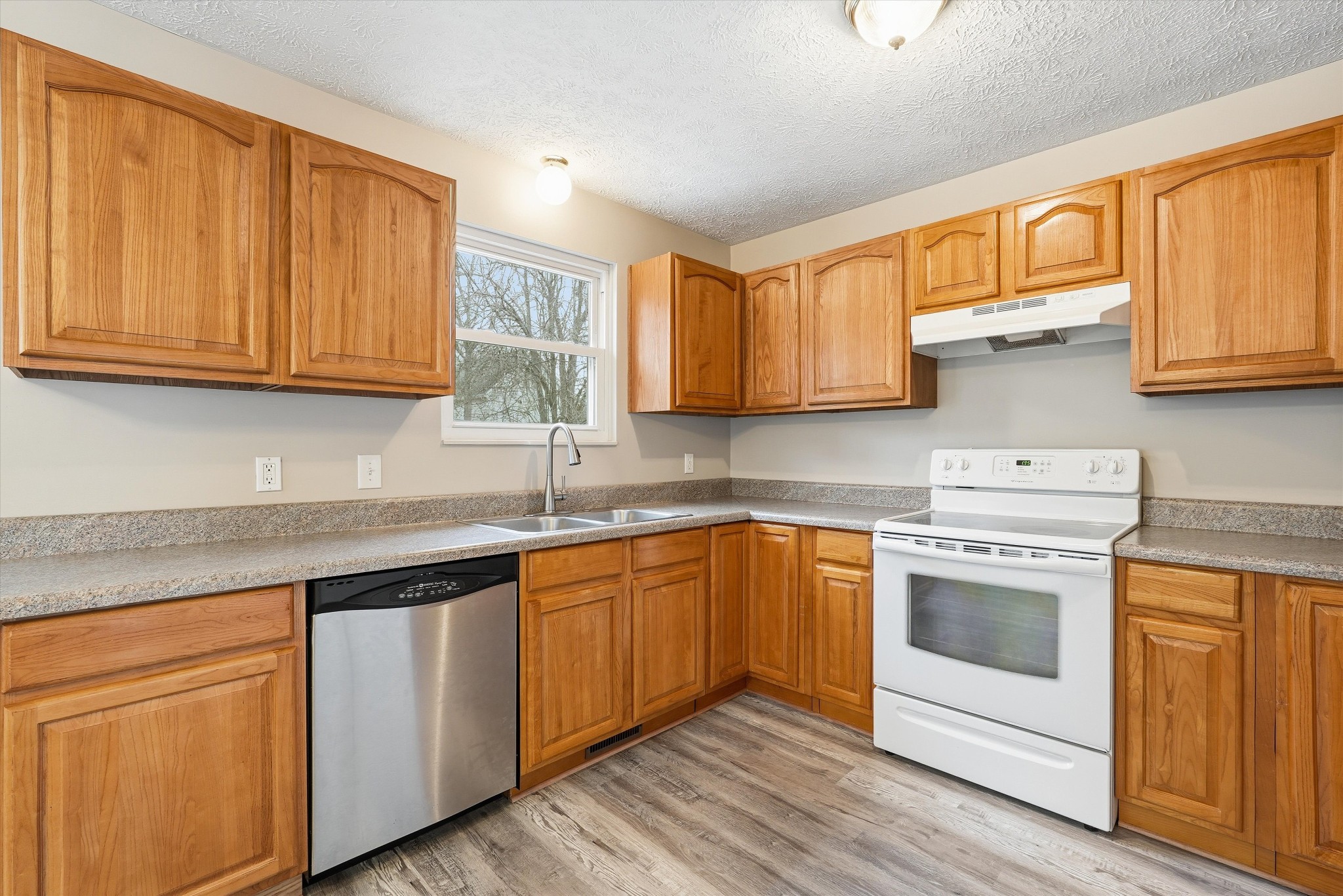 7641 Saundersville Road Mount Juliet, TN 37122 - Photo 13 of 29 a kitchen with granite countertop wooden cabinets stainless steel appliances and a sink