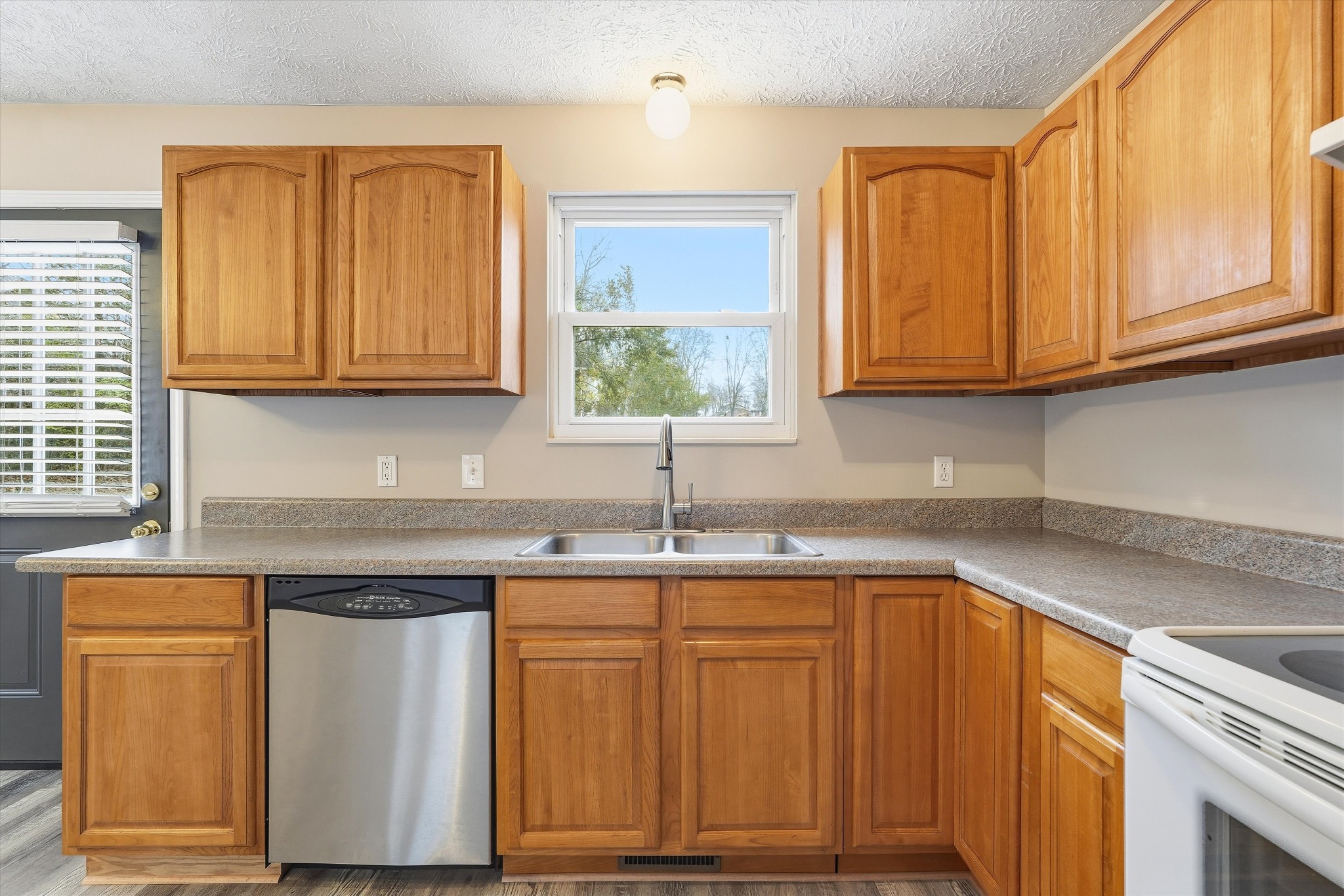7641 Saundersville Road Mount Juliet, TN 37122 - Photo 14 of 29 a kitchen with stainless steel appliances granite countertop wooden cabinets a sink and dishwasher