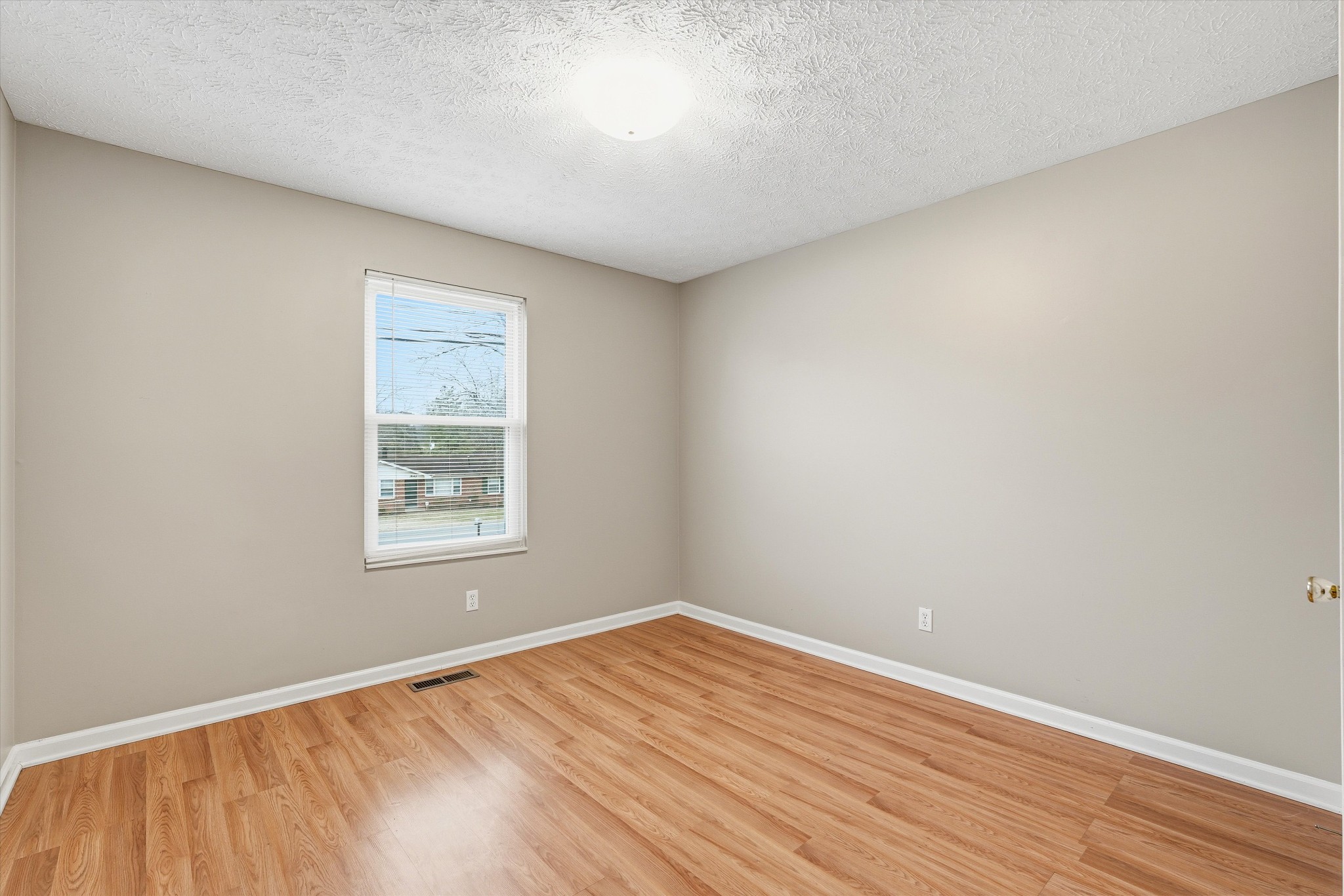 7641 Saundersville Road Mount Juliet, TN 37122 - Photo 18 of 29 an empty room with wooden floor and windows