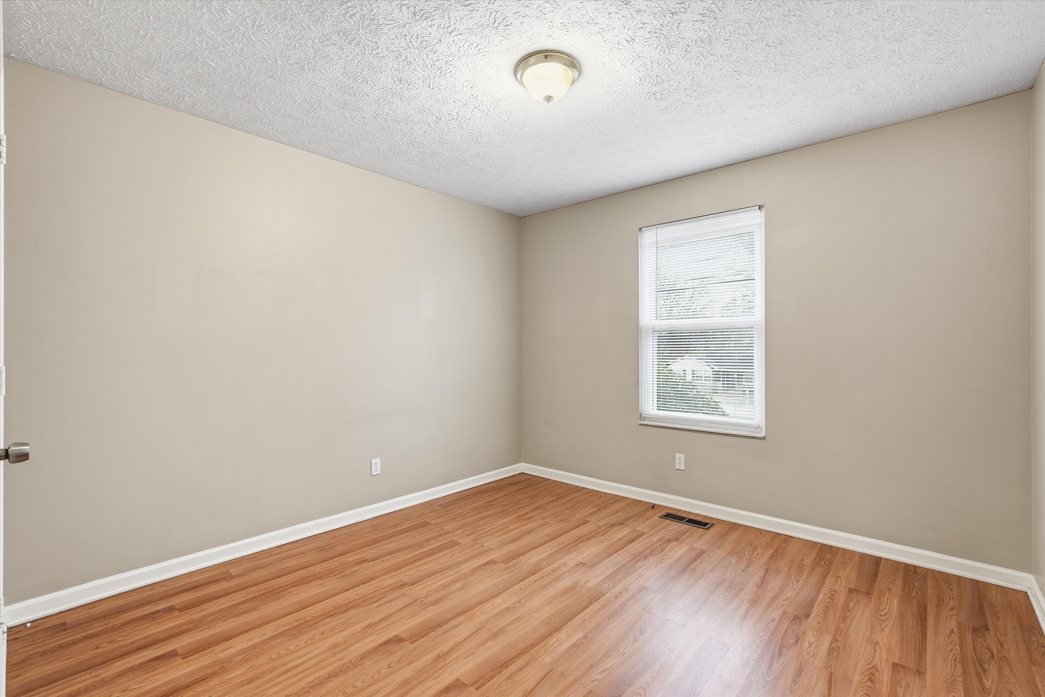 7641 Saundersville Road Mount Juliet, TN 37122 - Photo 20 of 29 an empty room with wooden floor and windows