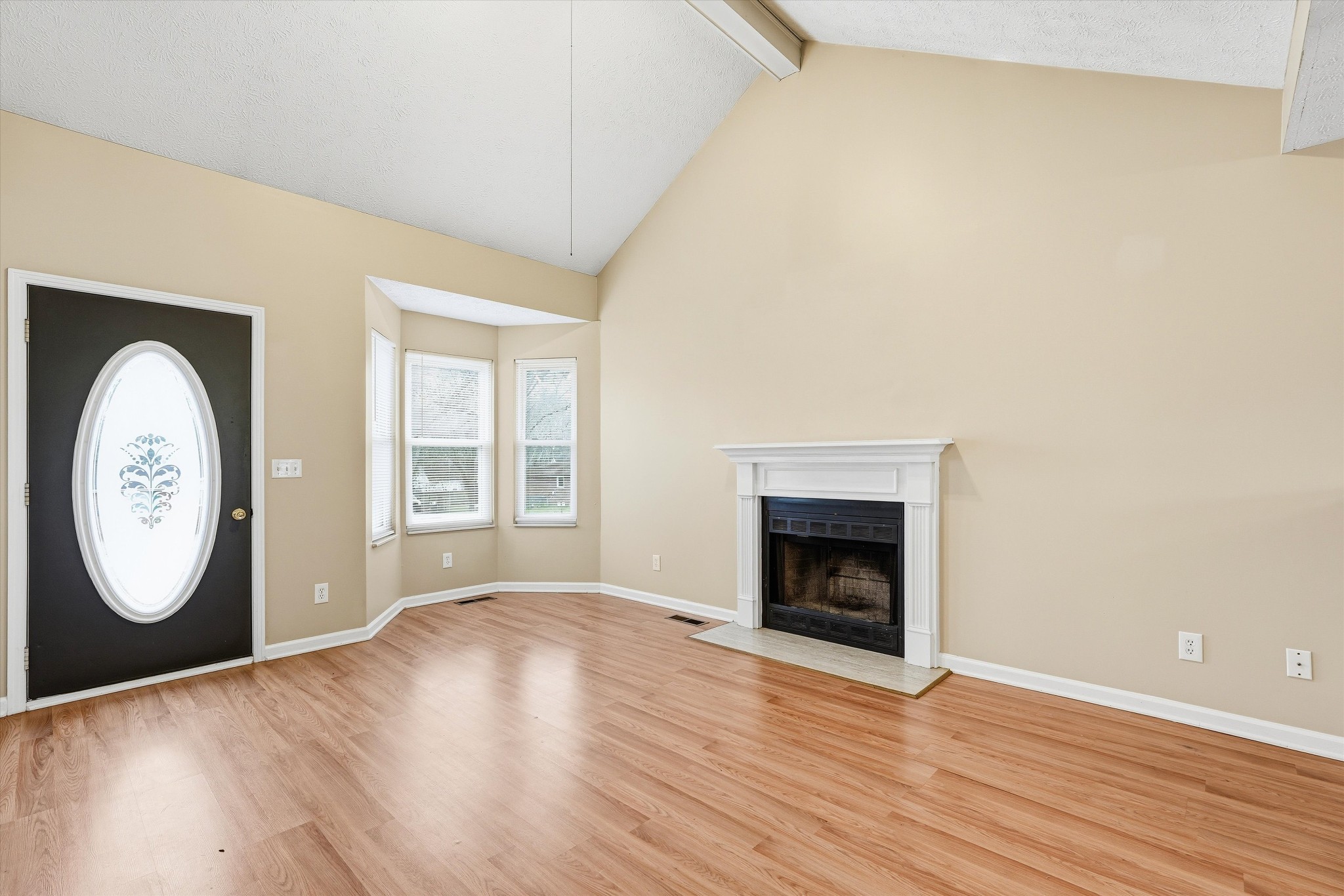 7641 Saundersville Road Mount Juliet, TN 37122 - Photo 3 of 29 a view of a livingroom with wooden floor a fireplace and a window