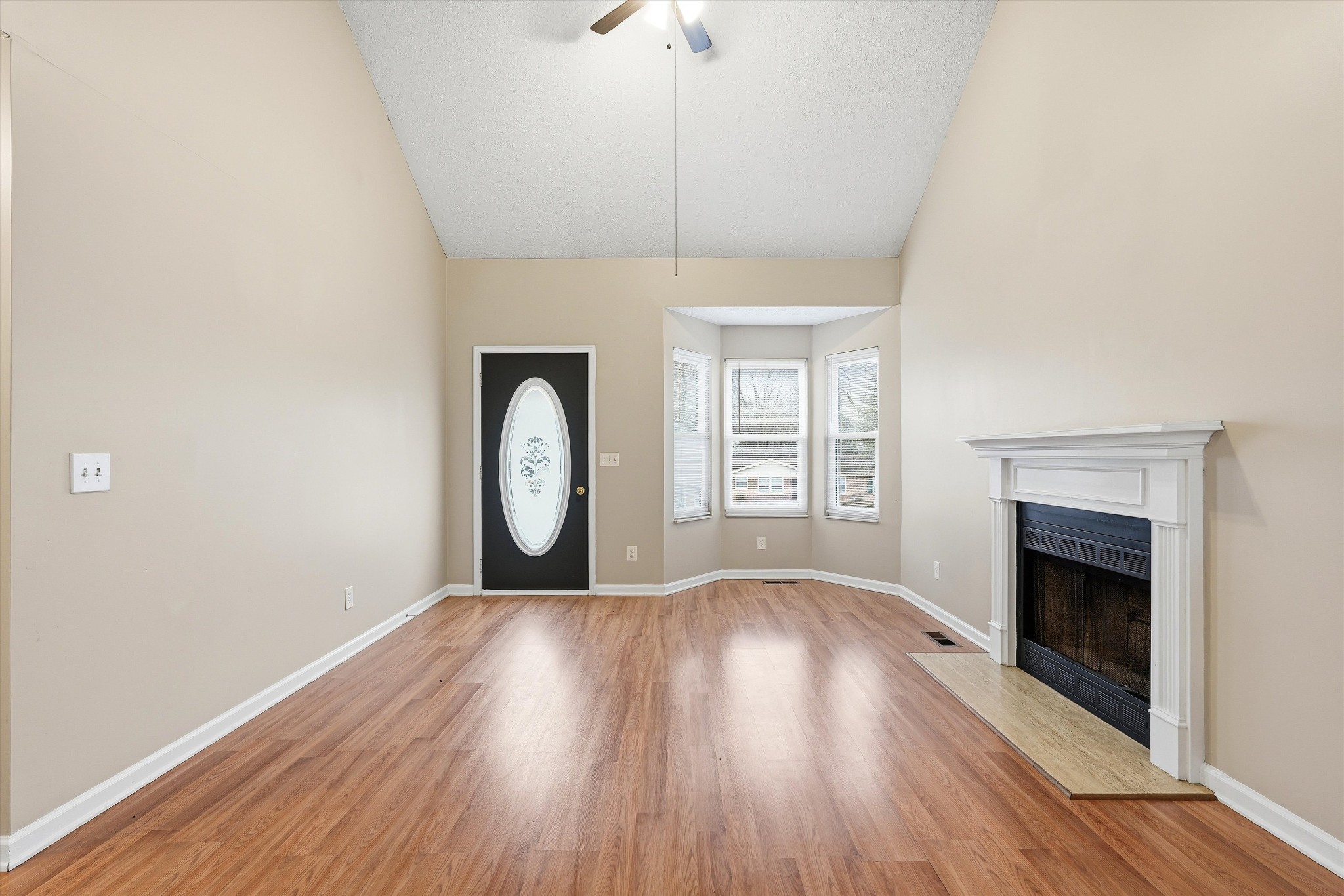 7641 Saundersville Road Mount Juliet, TN 37122 - Photo 4 of 29 an empty room with wooden floor fireplace and windows