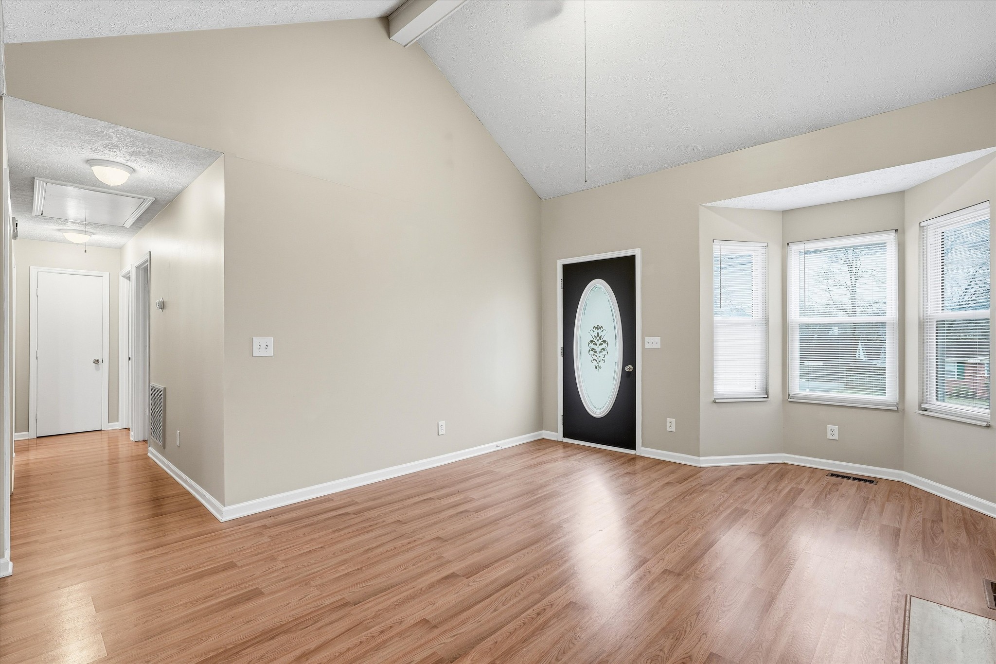 7641 Saundersville Road Mount Juliet, TN 37122 - Photo 5 of 29 a view of an empty room with wooden floor and a window