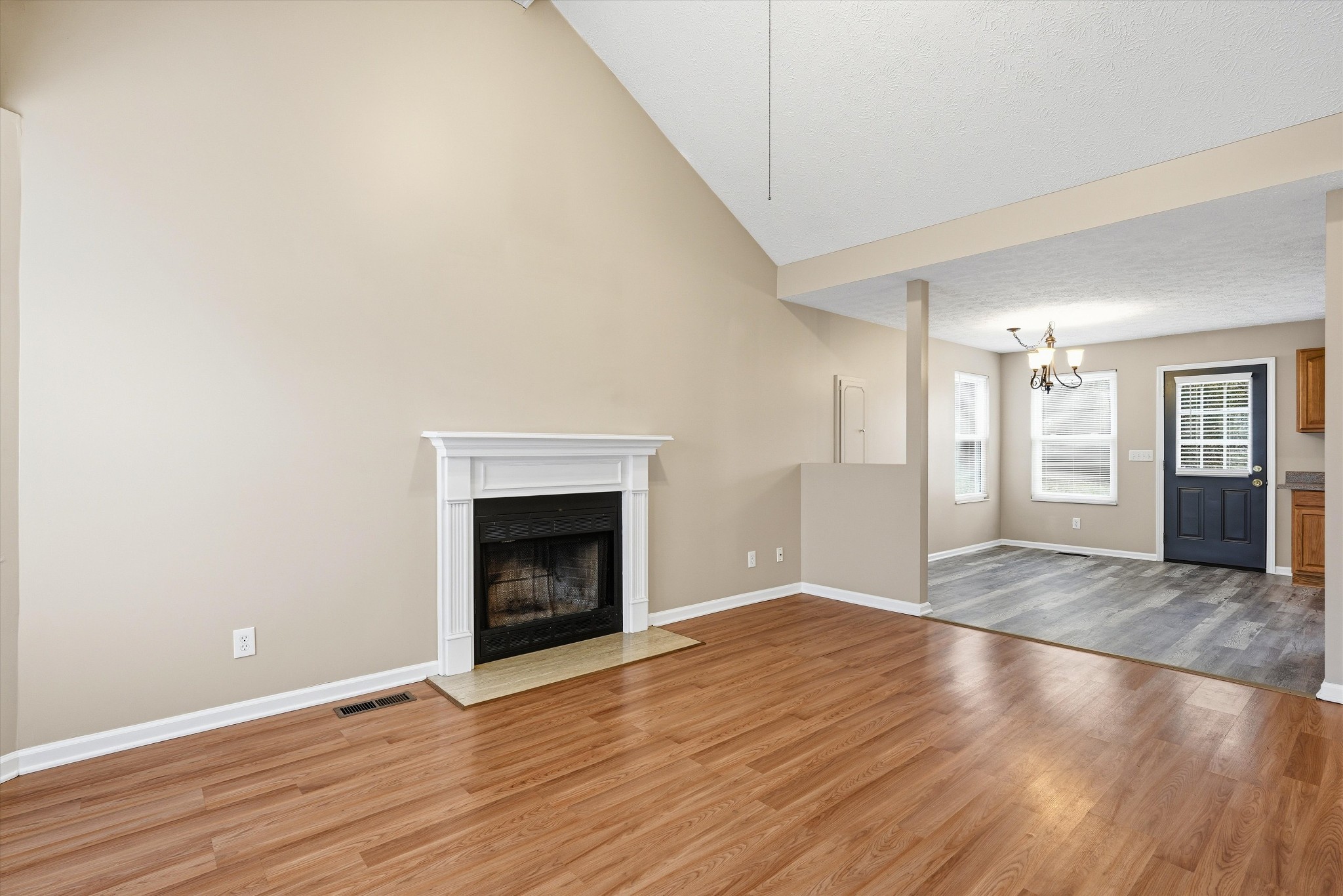 7641 Saundersville Road Mount Juliet, TN 37122 - Photo 6 of 29 a view of an empty room with wooden floor fireplace and a window