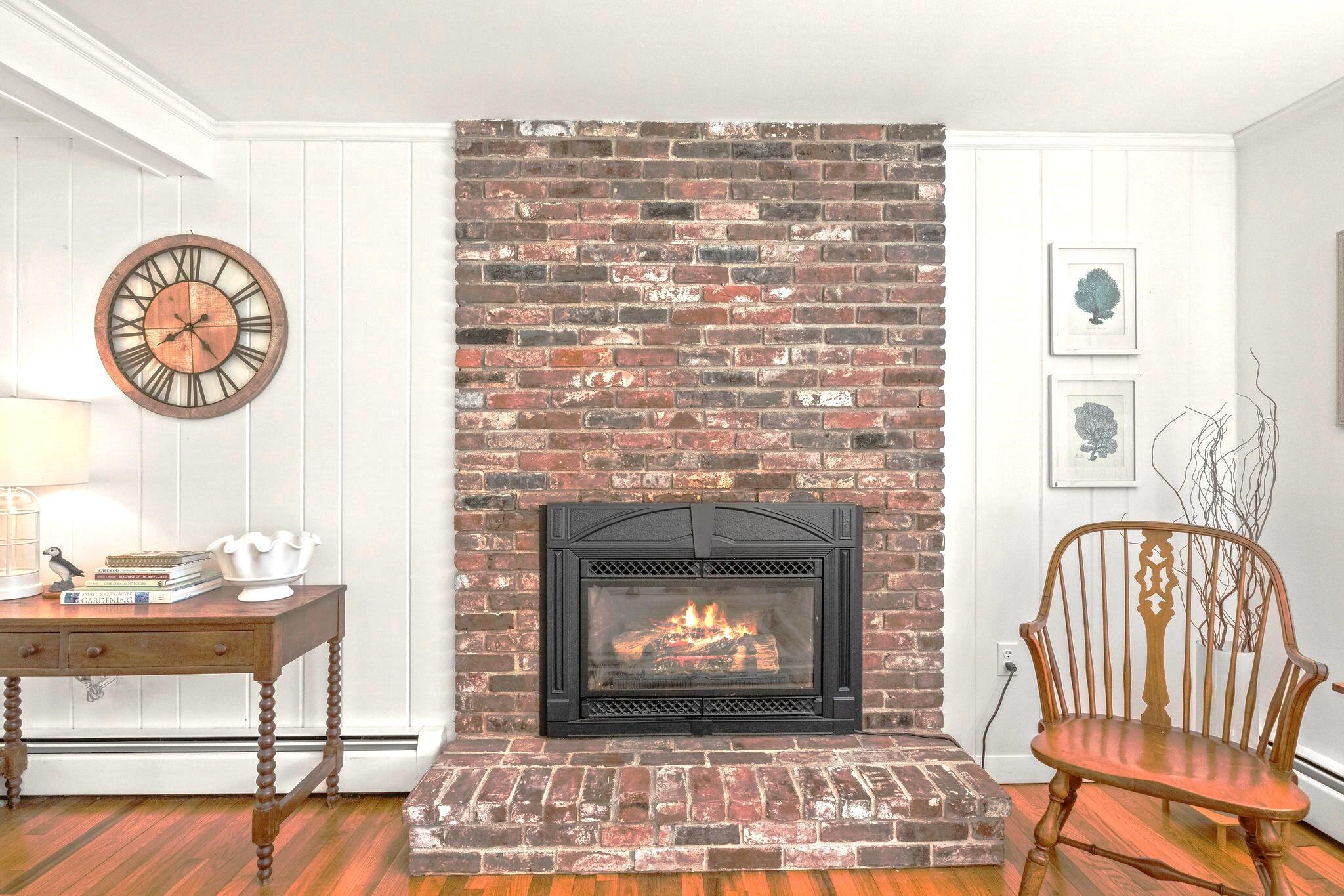 9 Doane Road Orleans, MA 02653 - Photo 12 of 31 a living room with a fireplace with wooden floor