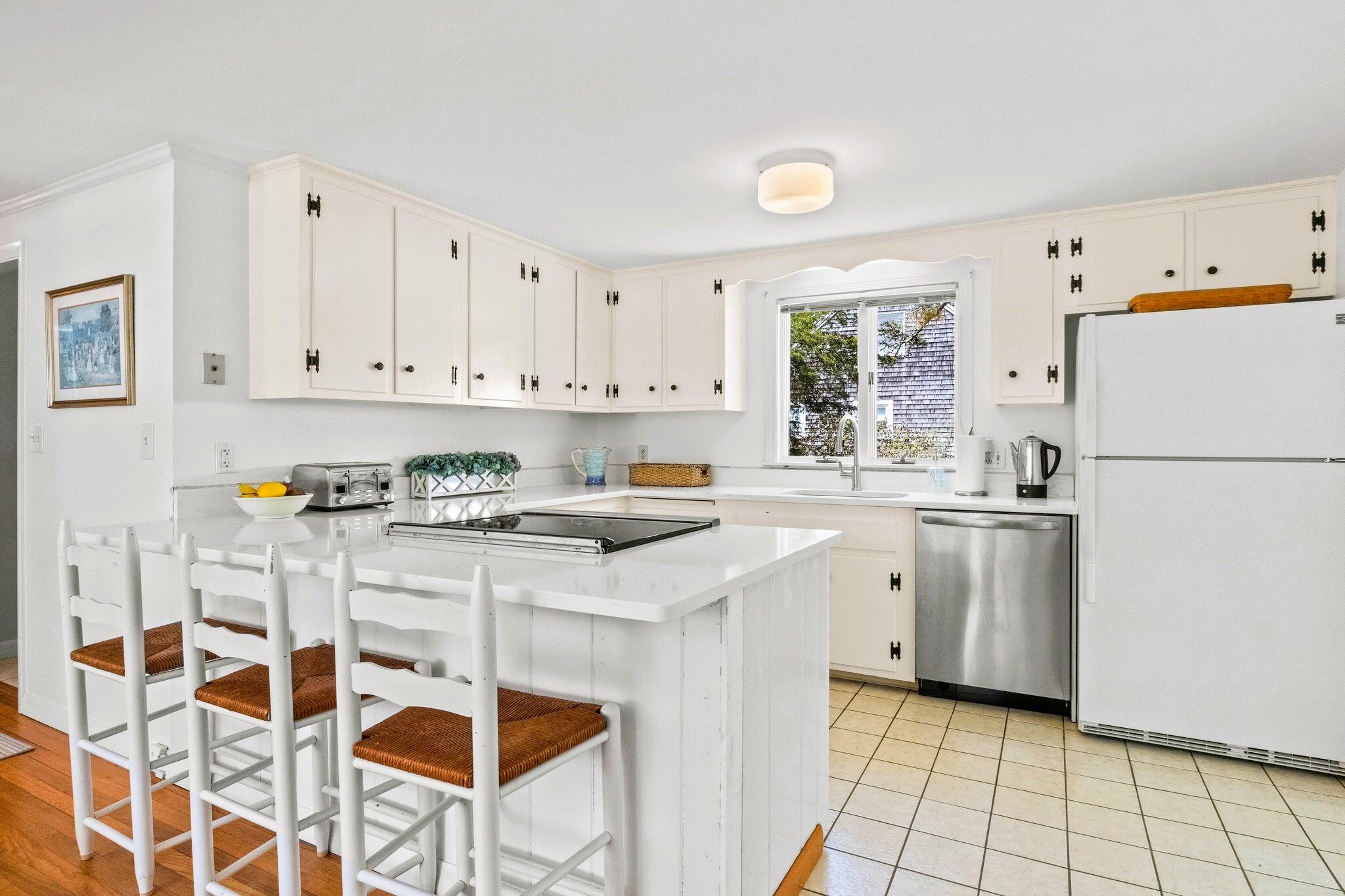 9 Doane Road Orleans, MA 02653 - Photo 14 of 31 a kitchen with a stove a sink and a refrigerator
