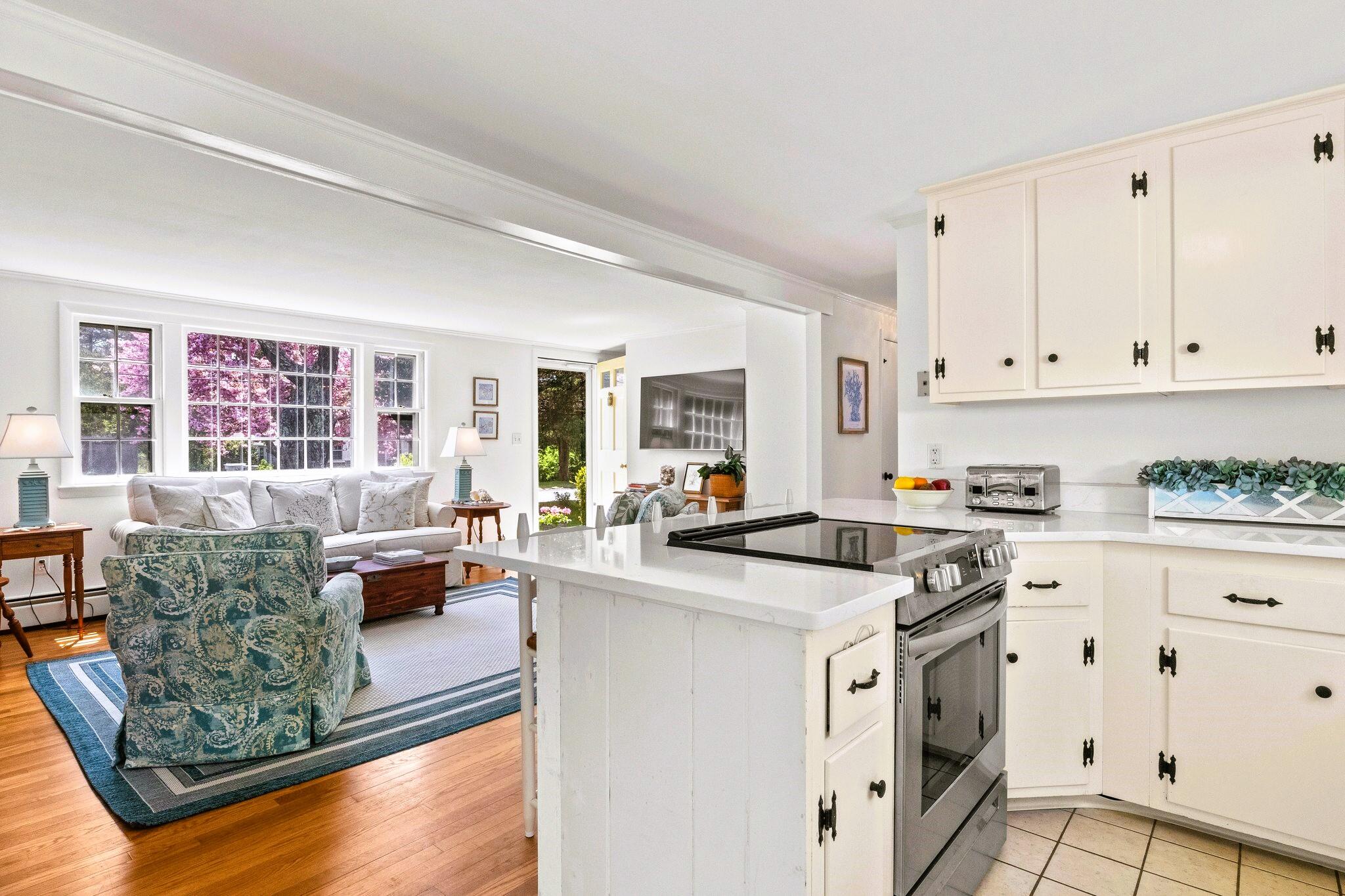 9 Doane Road Orleans, MA 02653 - Photo 15 of 31 a kitchen with stainless steel appliances granite countertop a stove a sink and white cabinets