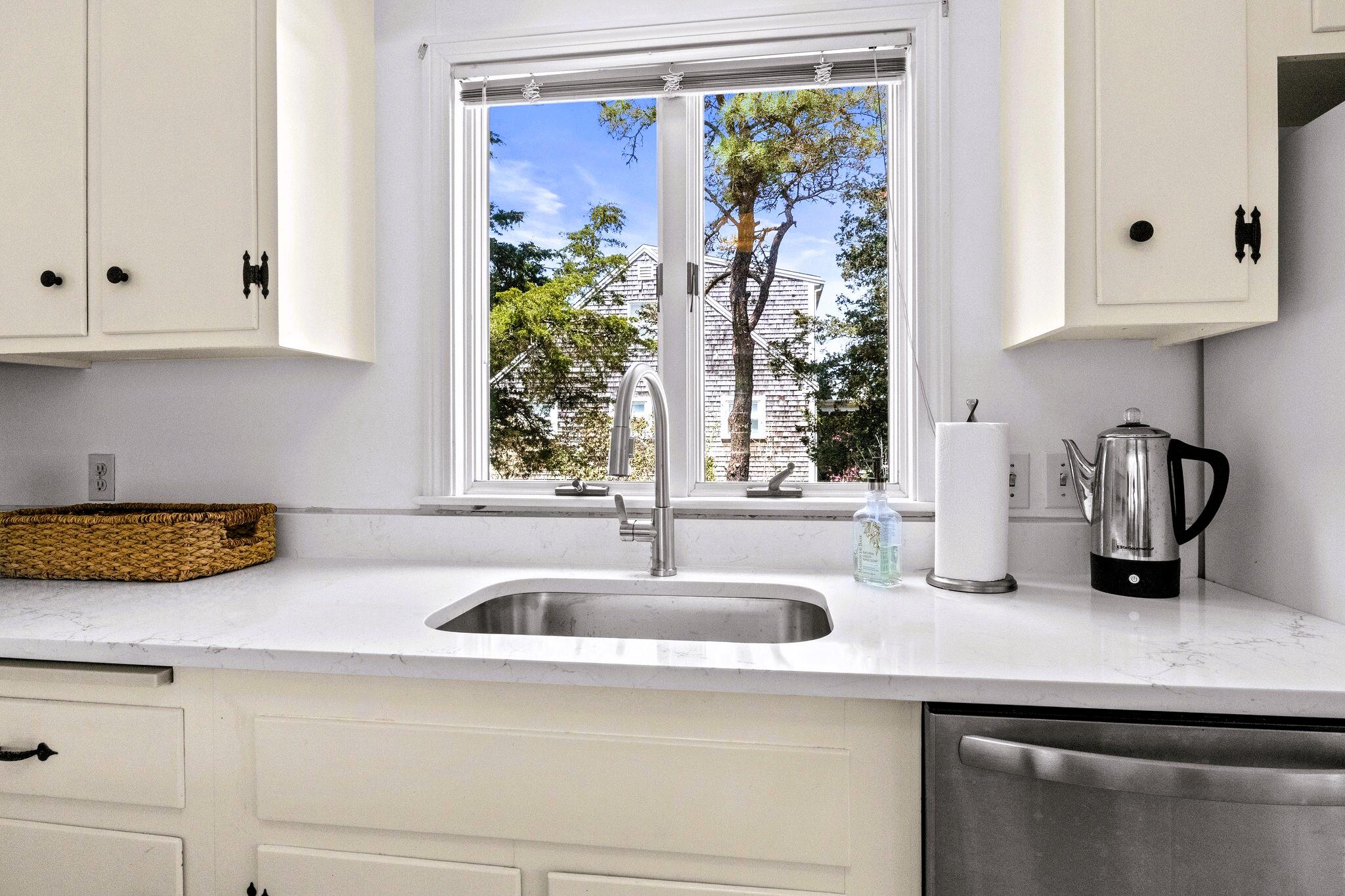 9 Doane Road Orleans, MA 02653 - Photo 16 of 31 a kitchen with stainless steel appliances granite countertop a sink and a white cabinets