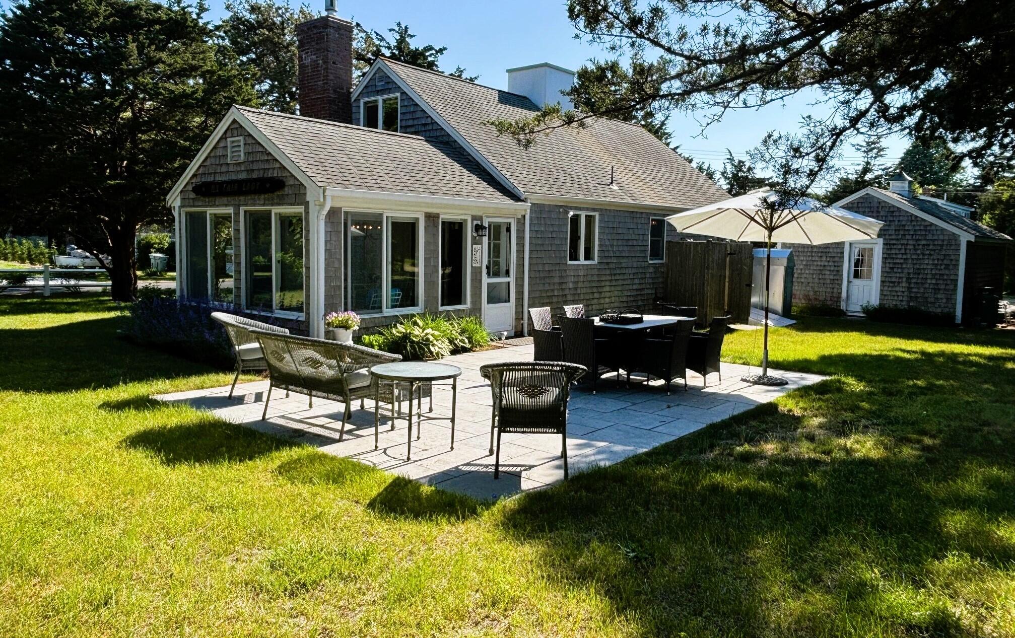 9 Doane Road Orleans, MA 02653 - Photo 28 of 31 a view of a house with a yard patio and fire pit