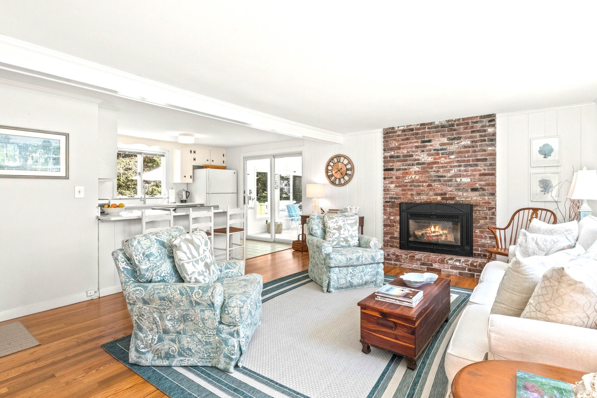 9 Doane Road Orleans, MA 02653 - Photo 10 of 31 a living room with furniture a fireplace and a flat screen tv