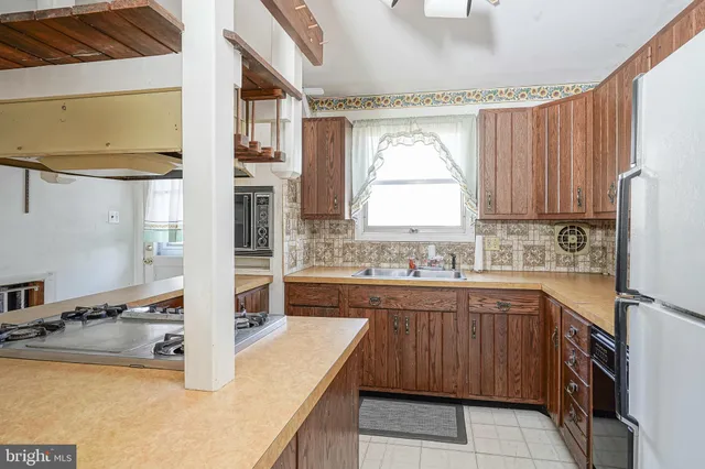a kitchen with a sink stove and cabinets