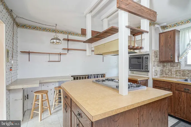 a kitchen with stainless steel appliances granite countertop a sink and a refrigerator