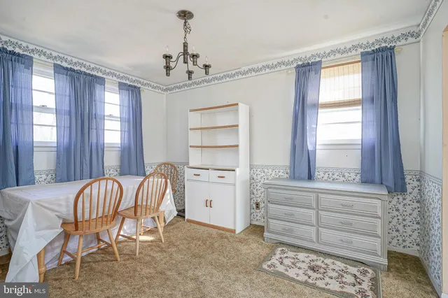 a bedroom with a bed and large windows