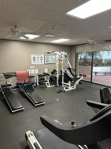 a room with gym equipment and a large window