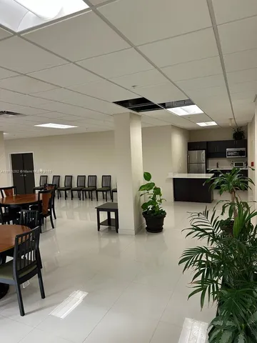 a lobby with furniture and a potted plant