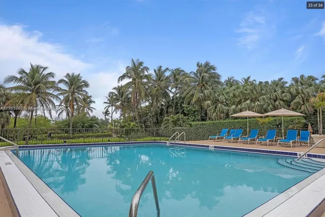 a view of swimming pool with outdoor seating and yard in back