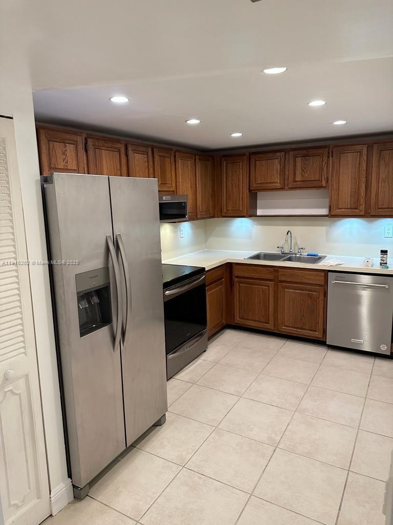 1621 Collins Avenue, Unit 505 Miami Beach, FL 33139 - Photo 10 of 25 a kitchen with stainless steel appliances a refrigerator sink and cabinets
