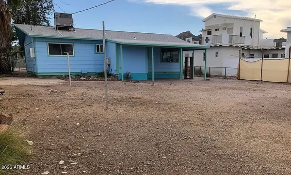 a view of a house with a backyard