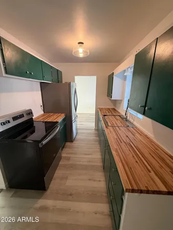 a kitchen with stainless steel appliances kitchen island granite countertop a refrigerator and a stove