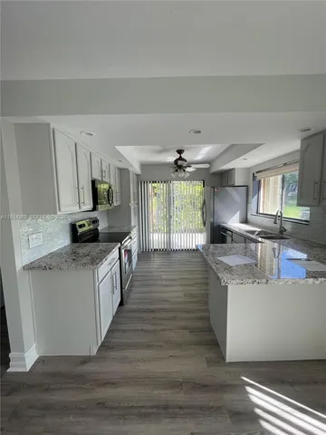 a kitchen with stainless steel appliances granite countertop a stove and a sink