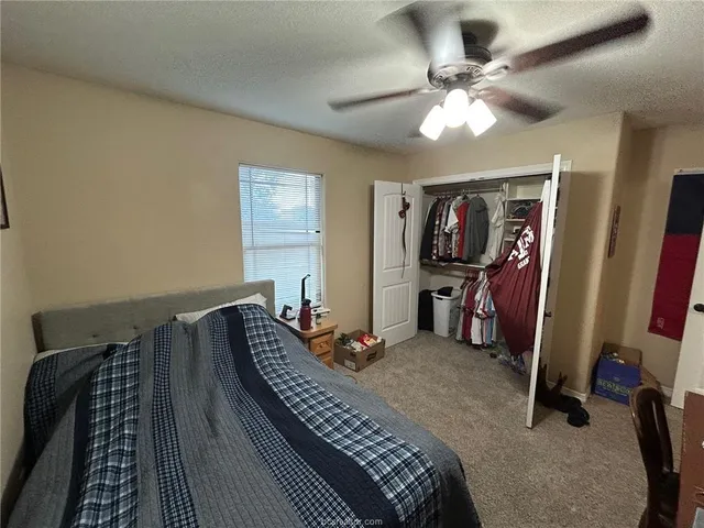 a bedroom with bed and wooden floor