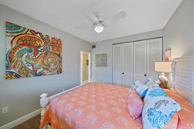 a bedroom with a bed and a painting on the wall