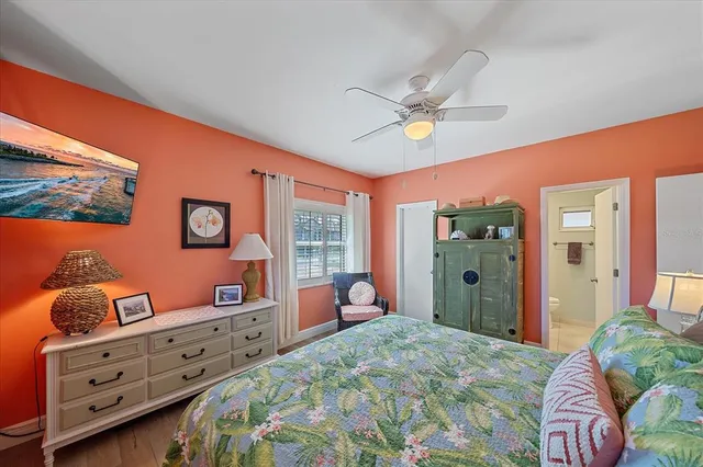 a bedroom with furniture and a large window