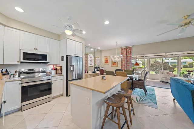 a large kitchen with kitchen island a large island in the center