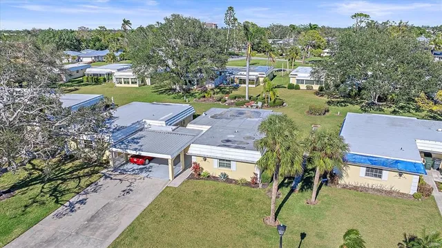 an aerial view of residential houses with outdoor space and street view