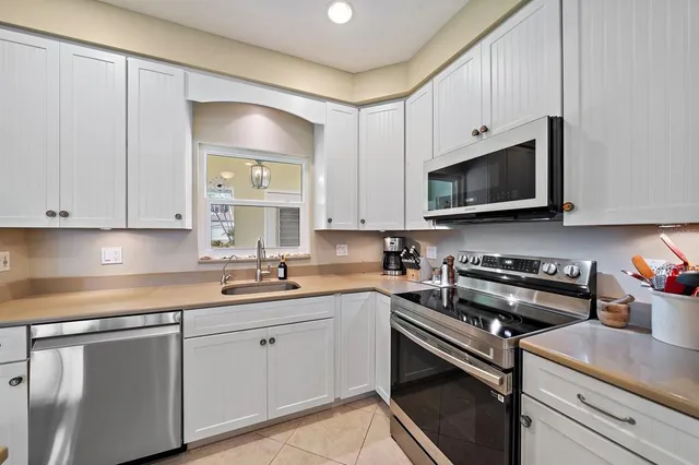 a kitchen with a sink stove and microwave