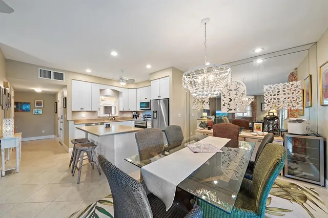 a large kitchen with a table and chairs