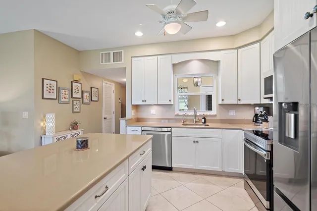 a kitchen with a sink cabinets and stainless steel appliances