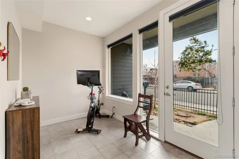 a kitchen with stainless steel appliances kitchen island granite countertop a stove a refrigerator a sink a dining table and chairs with wooden floor
