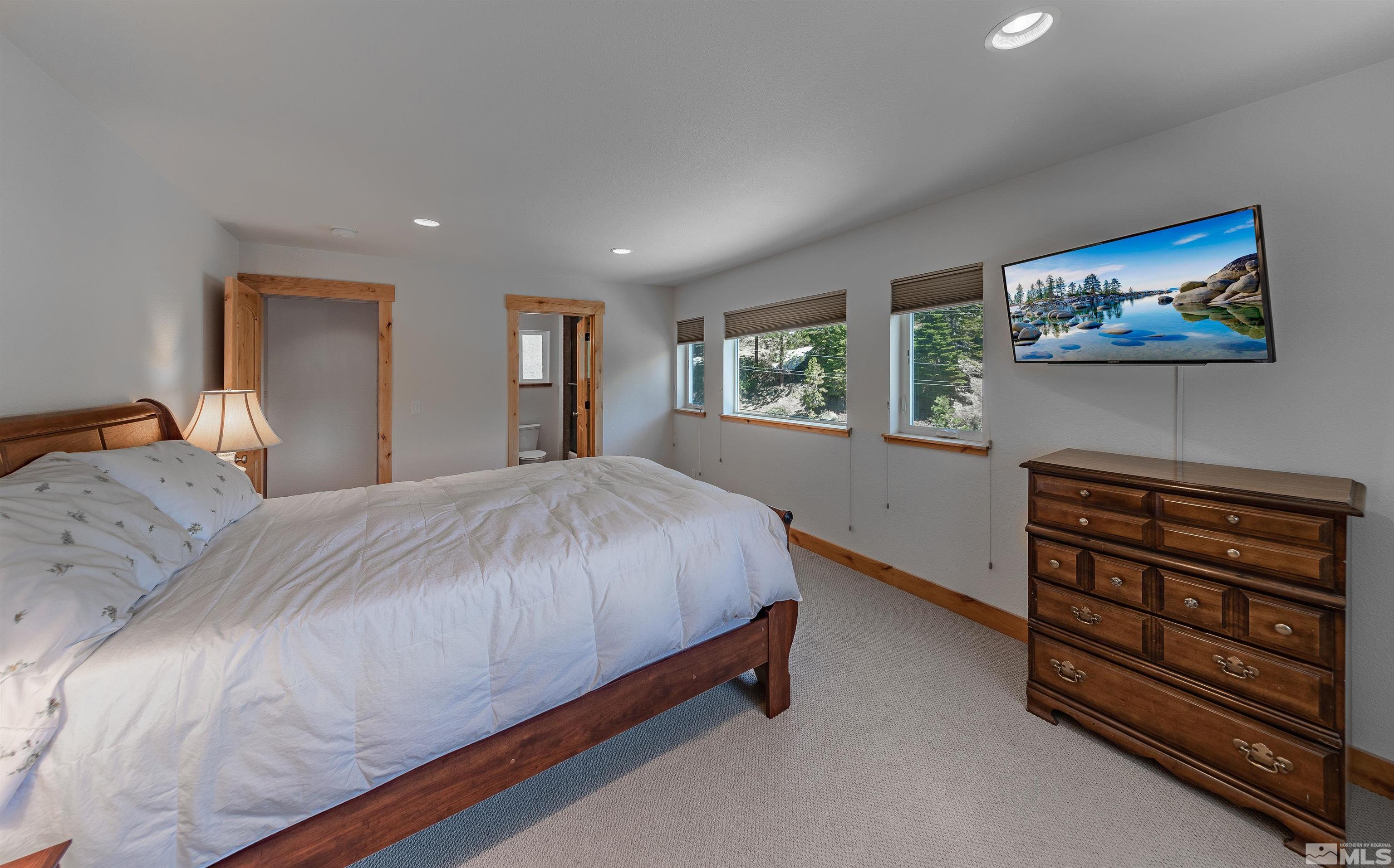 278 Andria Drive Stateline, NV 89449 - Photo 16 of 37 a bedroom with a bed and a dresser next to a window