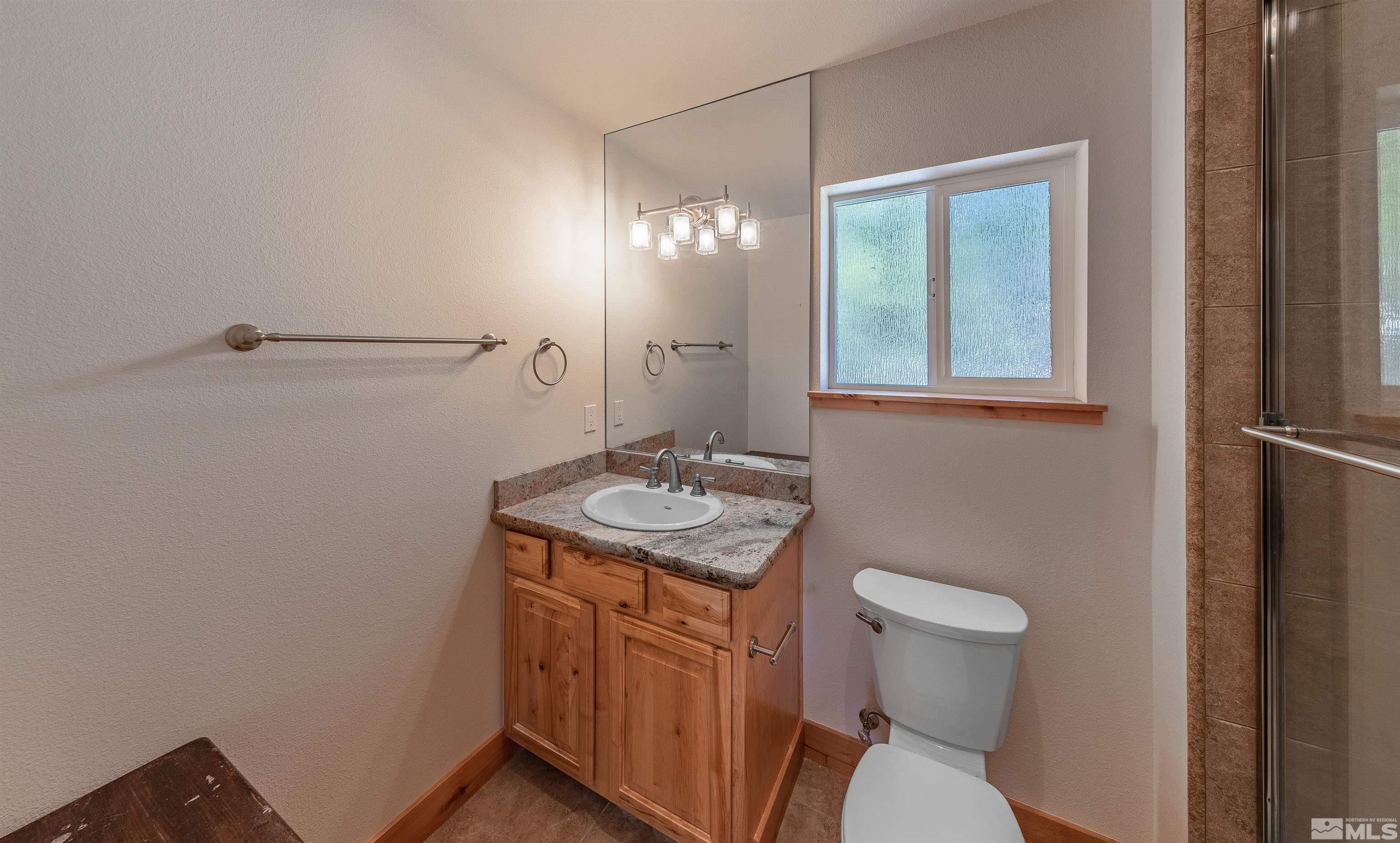 278 Andria Drive Stateline, NV 89449 - Photo 17 of 37 a bathroom with a sink a toilet and mirror