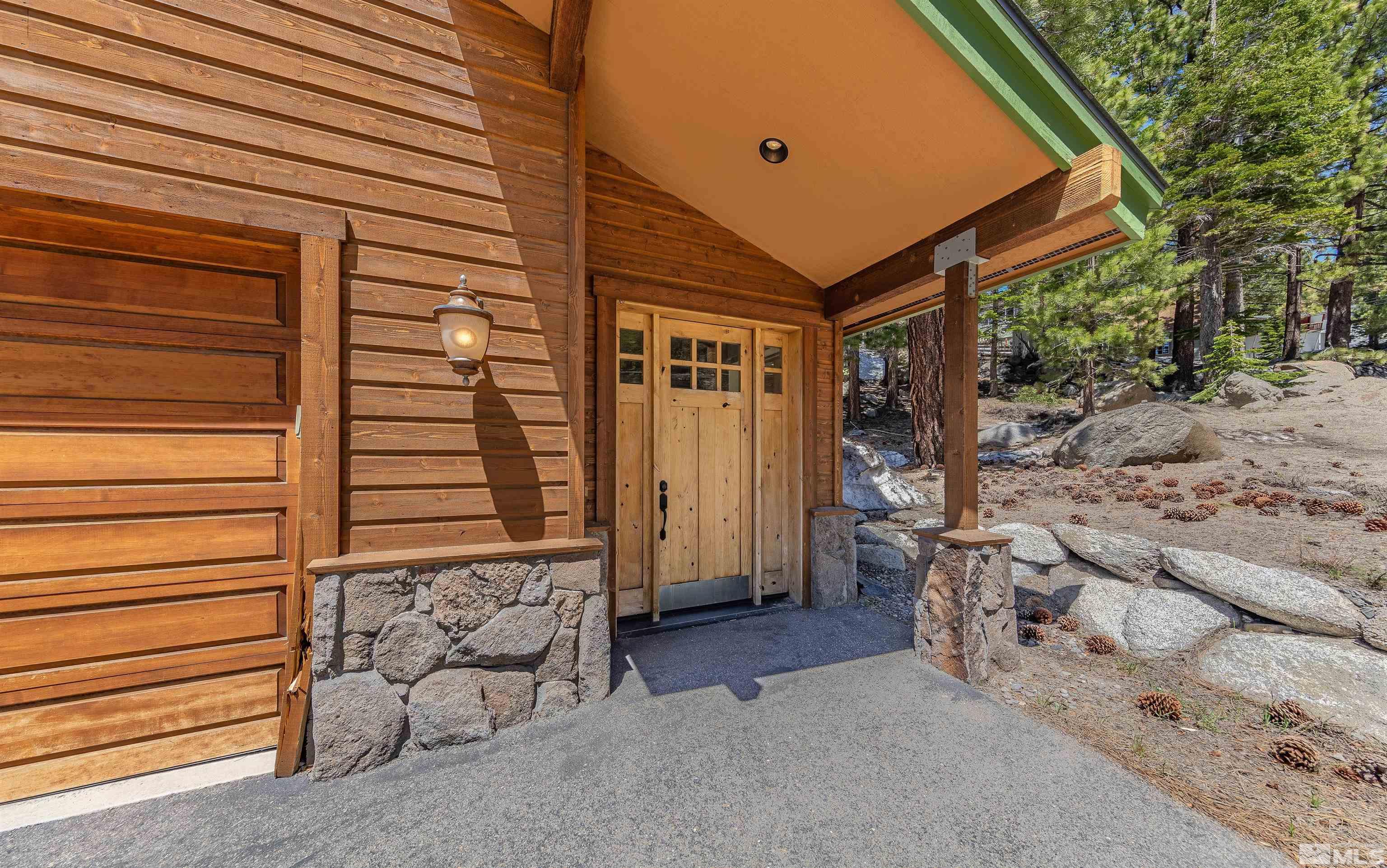 278 Andria Drive Stateline, NV 89449 - Photo 2 of 37 a backyard of a house with dishwasher and wooden fence