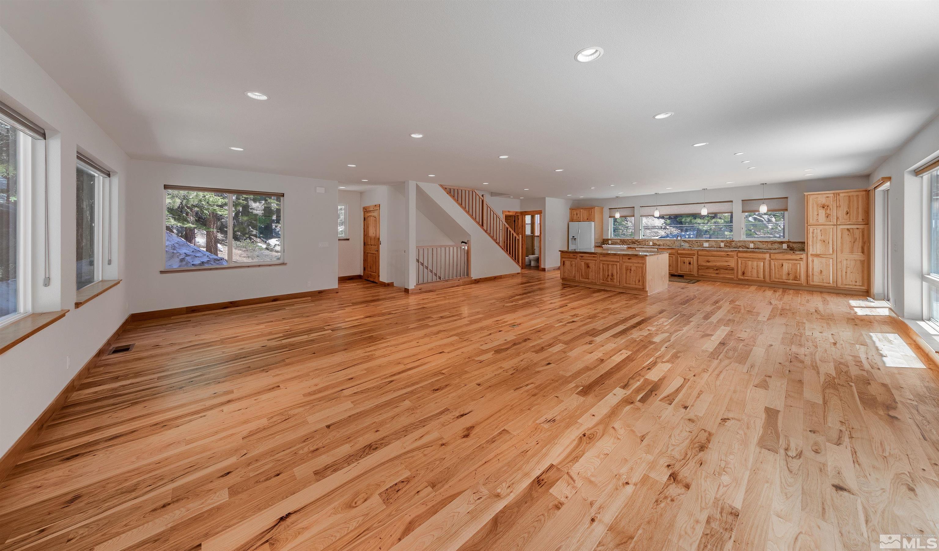 278 Andria Drive Stateline, NV 89449 - Photo 4 of 37 an empty room with wooden floor and windows