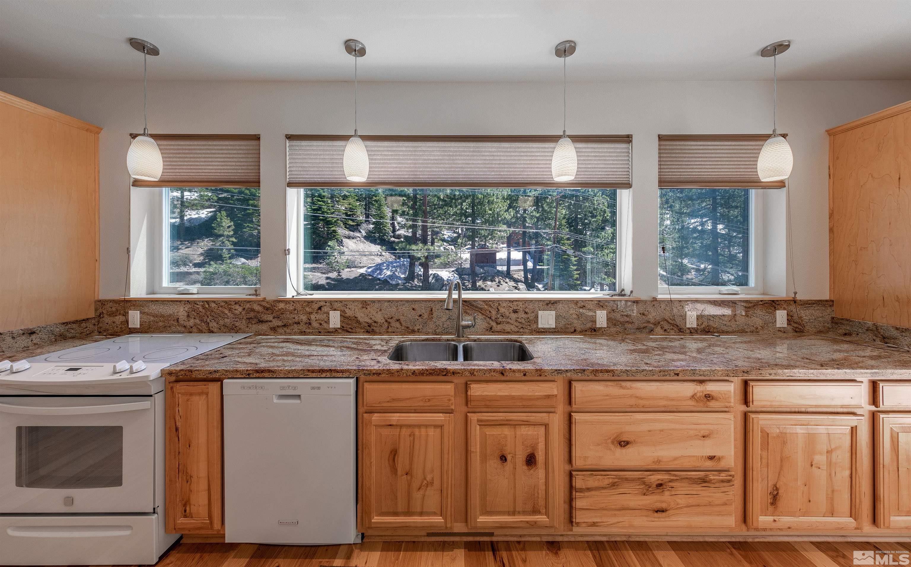 278 Andria Drive Stateline, NV 89449 - Photo 7 of 37 a kitchen with granite countertop a sink and a window