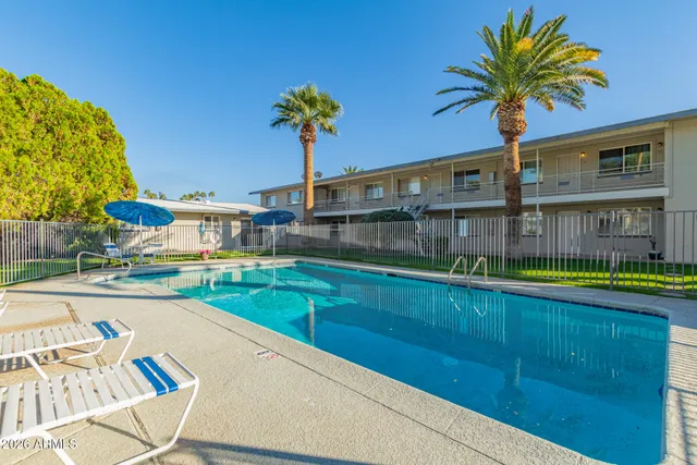 a view of a house with swimming pool yard and outdoor seating