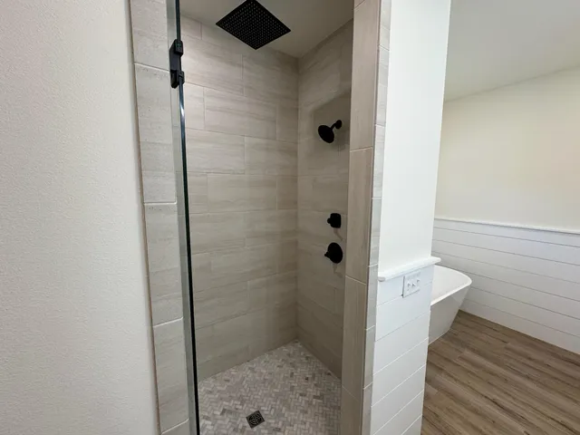 a bathroom with a shower and toilet
