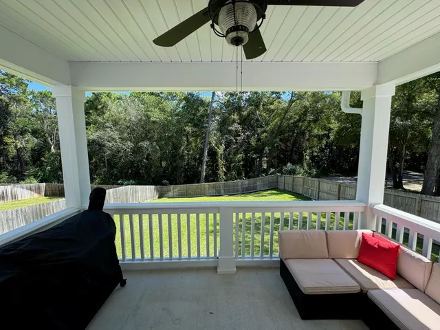 a balcony with furniture and a potted plant
