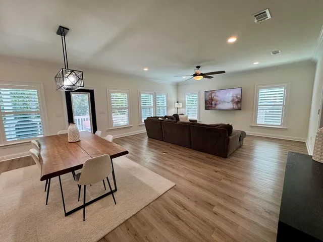 a view of a livingroom with furniture window and wooden floor