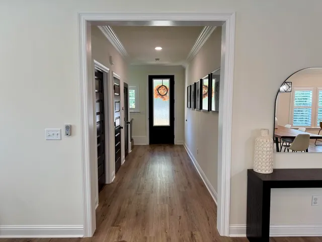a view of hallway with wooden floor