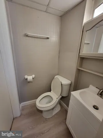 a white toilet sitting next to a bathroom sink