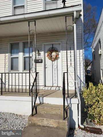 a view of a porch with a table and chairs