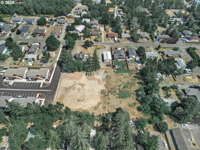 an aerial view of a house with a yard and lake view